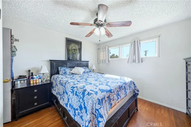 a bedroom with a bed and a dresser with mirror