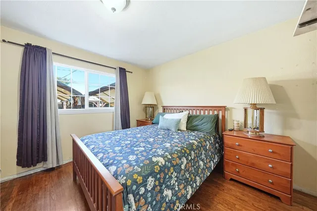 a bedroom with a large bed and a dresser