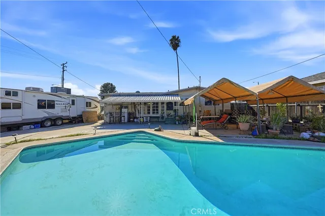 a swimming pool with outdoor seating