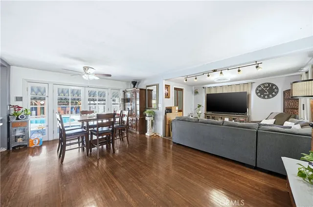 a view of a dining room with furniture and wooden floor