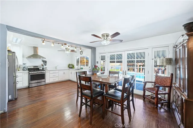 a large open kitchen with stainless steel appliances granite countertop a stove and cabinets with wooden floor