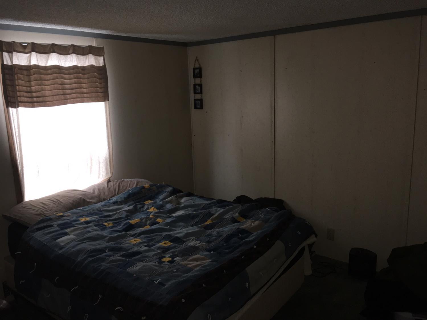 301 Queens Branch Road Rogue River, OR 97537 - Photo 13 of 13 a bedroom with a bed and a window