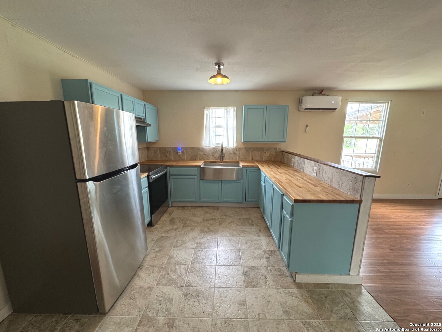 14016 Fm 470 Tarpley, TX 78883 - Photo 1 of 1 a kitchen with granite countertop a refrigerator and a sink
