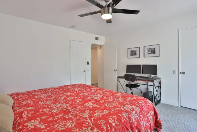 a bedroom with a bed and a chair