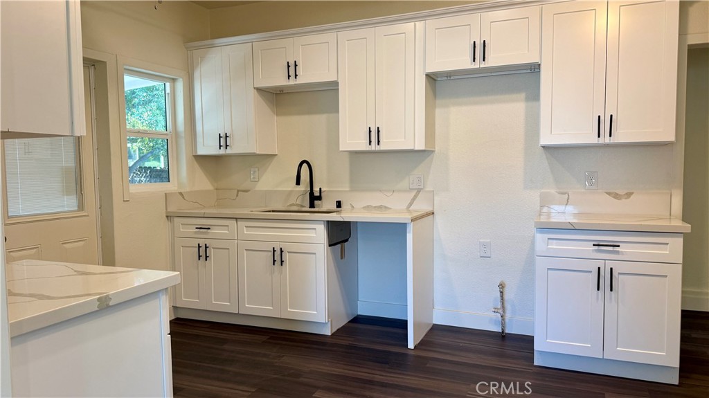 4542 Bandini Avenue Riverside, CA 92506 - Photo 10 of 22 a kitchen with stainless steel appliances granite countertop a sink stove and cabinets