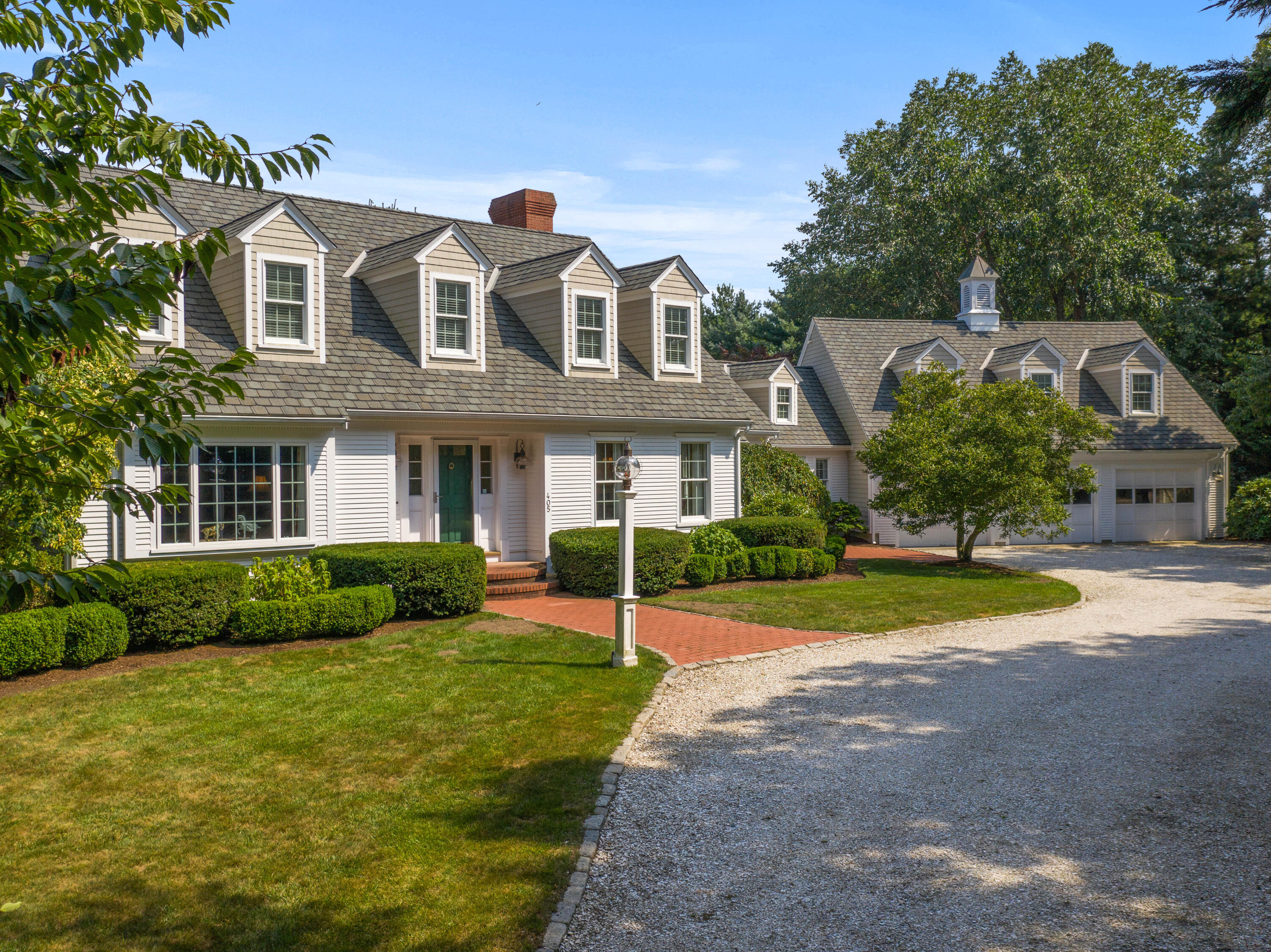 405 Baxter Neck Road Marstons Mills, MA 02648 - Photo 3 of 36 a front view of a house with a yard and garage