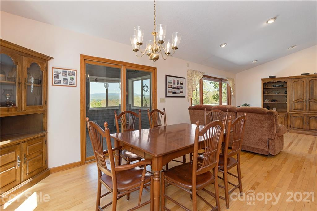 5561 Spring Road Hendersonville, NC 28739 - Photo 12 of 30 a view of a dining room with furniture and chandelier