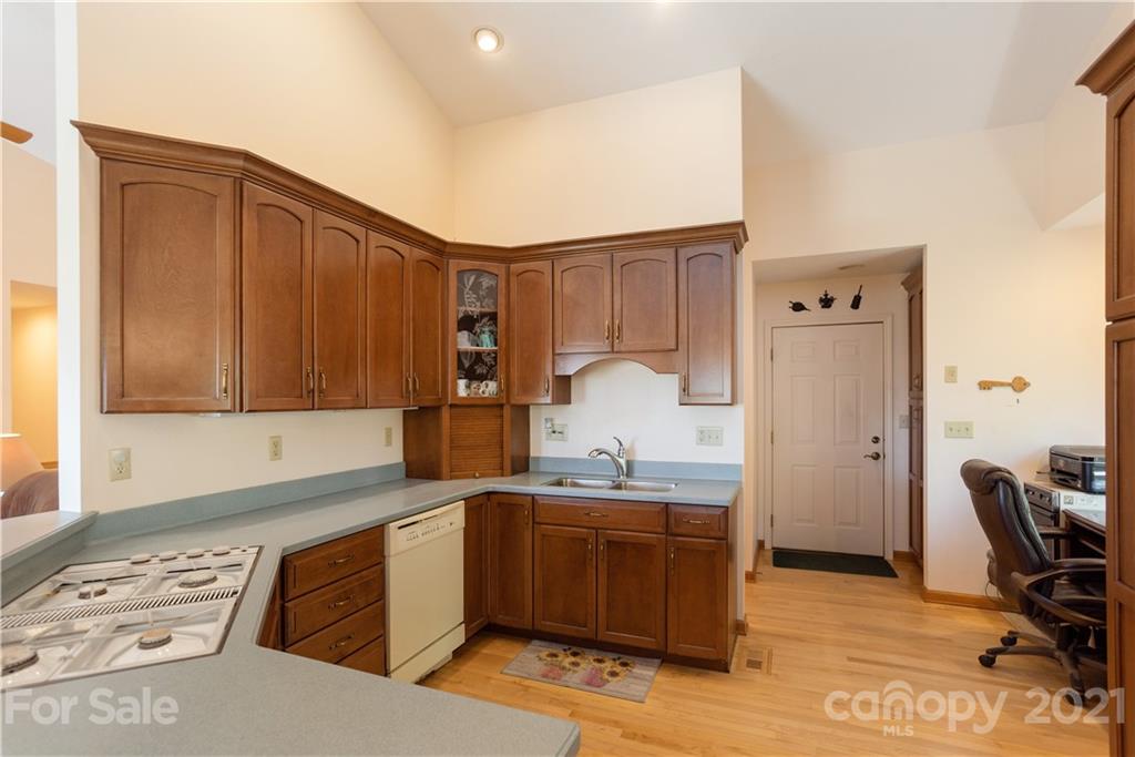 5561 Spring Road Hendersonville, NC 28739 - Photo 13 of 30 a kitchen with a sink cabinets and wooden floor