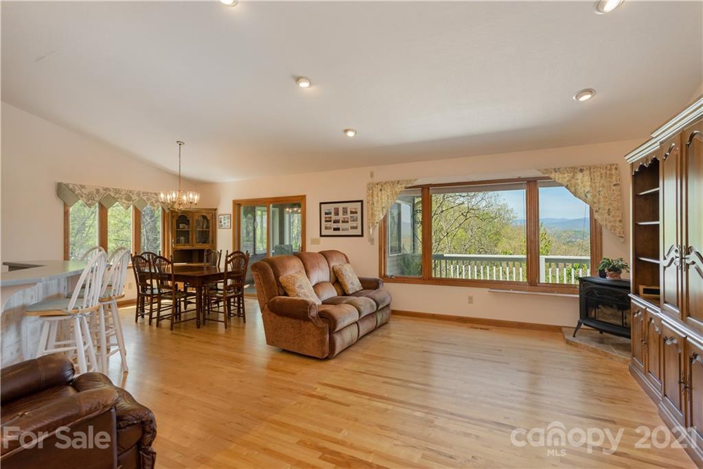 5561 Spring Road Hendersonville, NC 28739 - Photo 9 of 30 a living room with furniture large windows and wooden floor