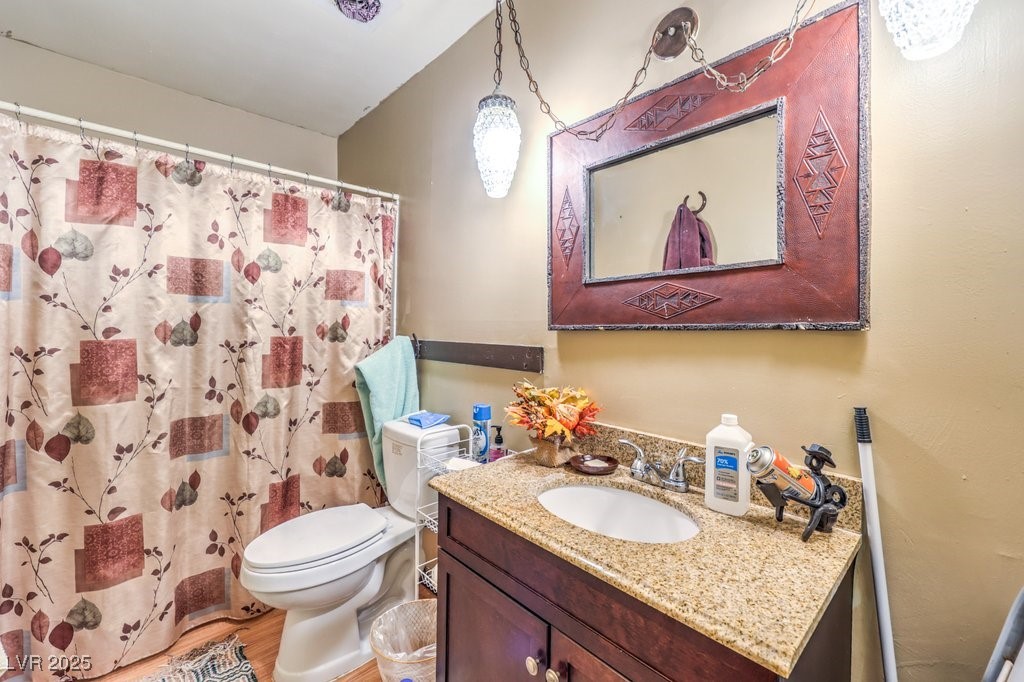 4216 North Decatur Boulevard North Las Vegas, NV 89032 - Photo 14 of 36 Full bathroom with vanity, light wood finished floors, and curtained shower