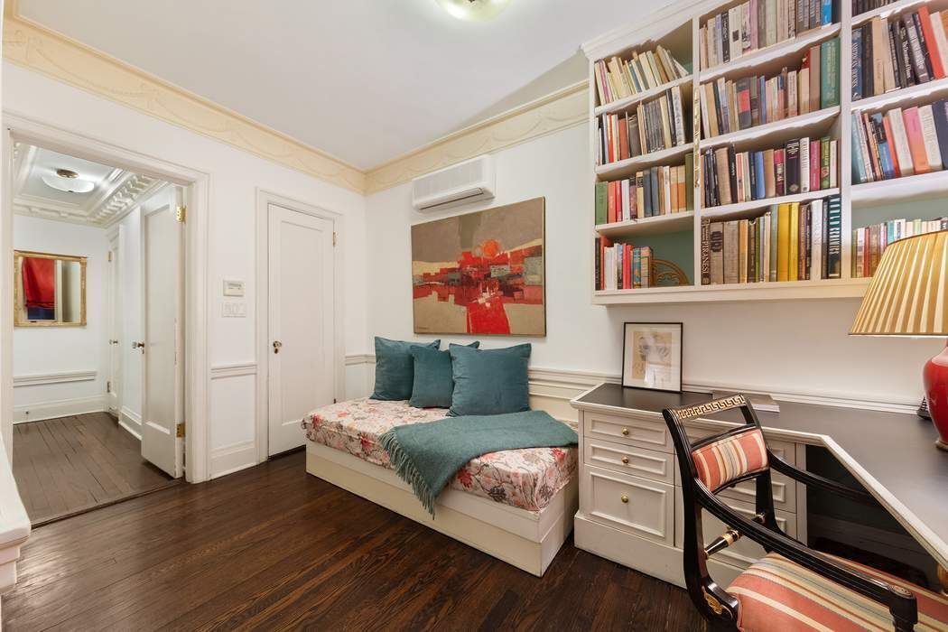 11 East 73rd Street, Unit 1D Manhattan, NY 10021 - Photo 12 of 18 a living room with furniture and a book shelf