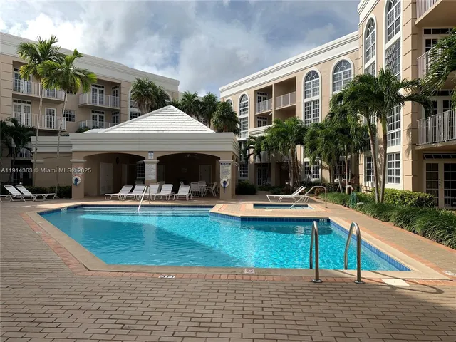 a view of a house with swimming pool and sitting area