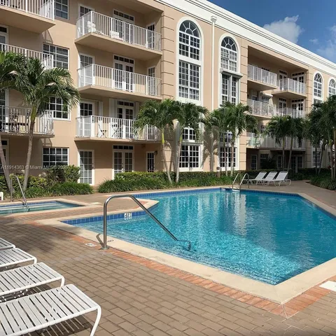 a swimming pool view with a outdoor seating