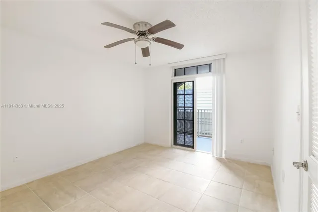 an empty room with closet and fan