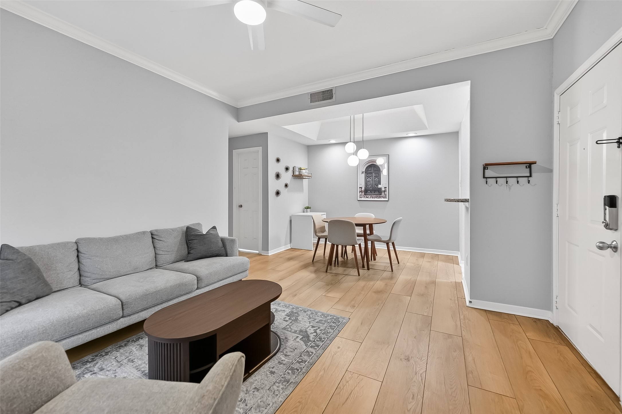 a living room with furniture and wooden floor
