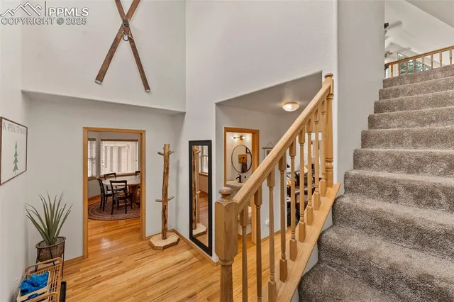 a view of entryway and hall with wooden floor