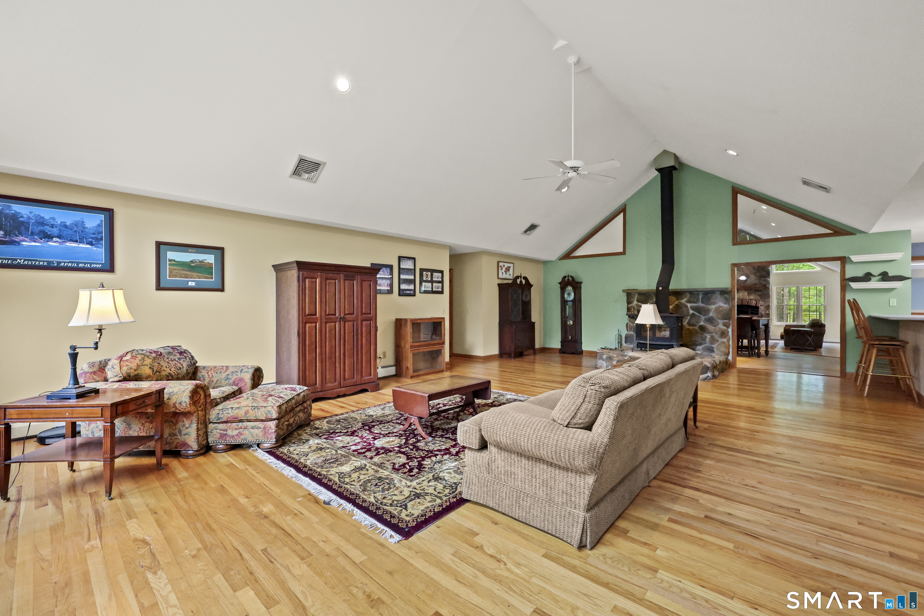 96 Spak Road Willington, CT 06279 - Photo 8 of 40 Front living room with vaulted ceilings, hardwood floors, & wall of windows capturing sweeping views of surrounding landscape.