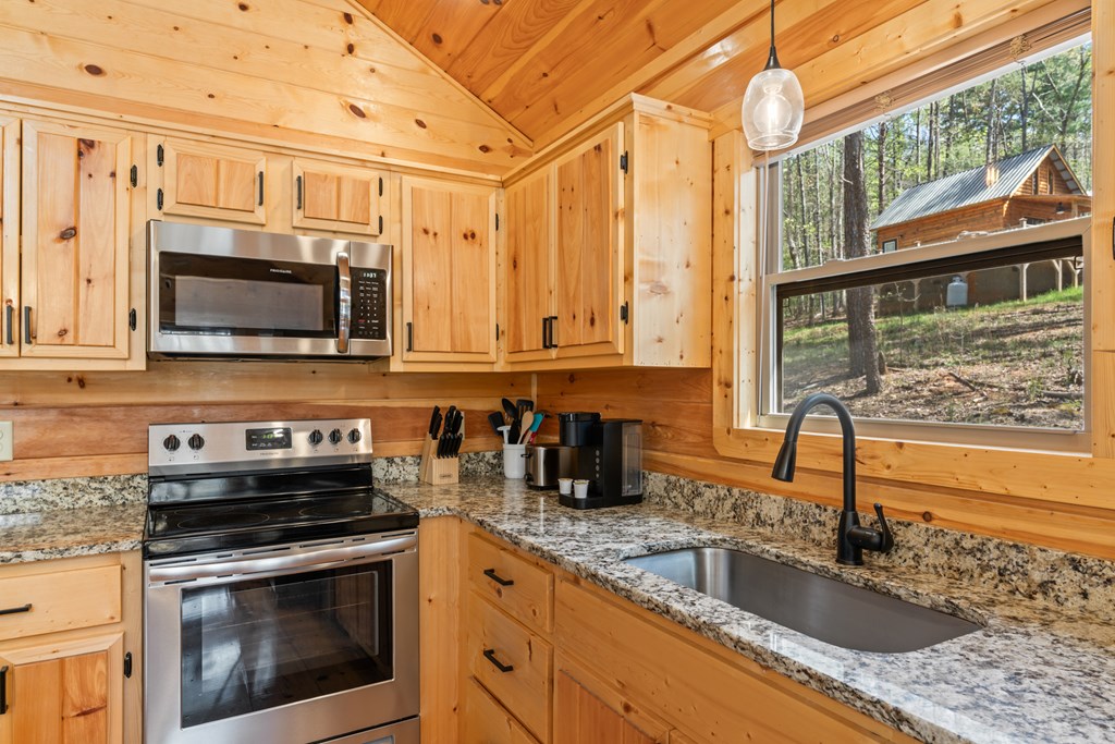 237 Bentley Cove Murphy, NC 28906 - Photo 12 of 43 a kitchen with stainless steel appliances granite countertop a sink a stove and a microwave oven