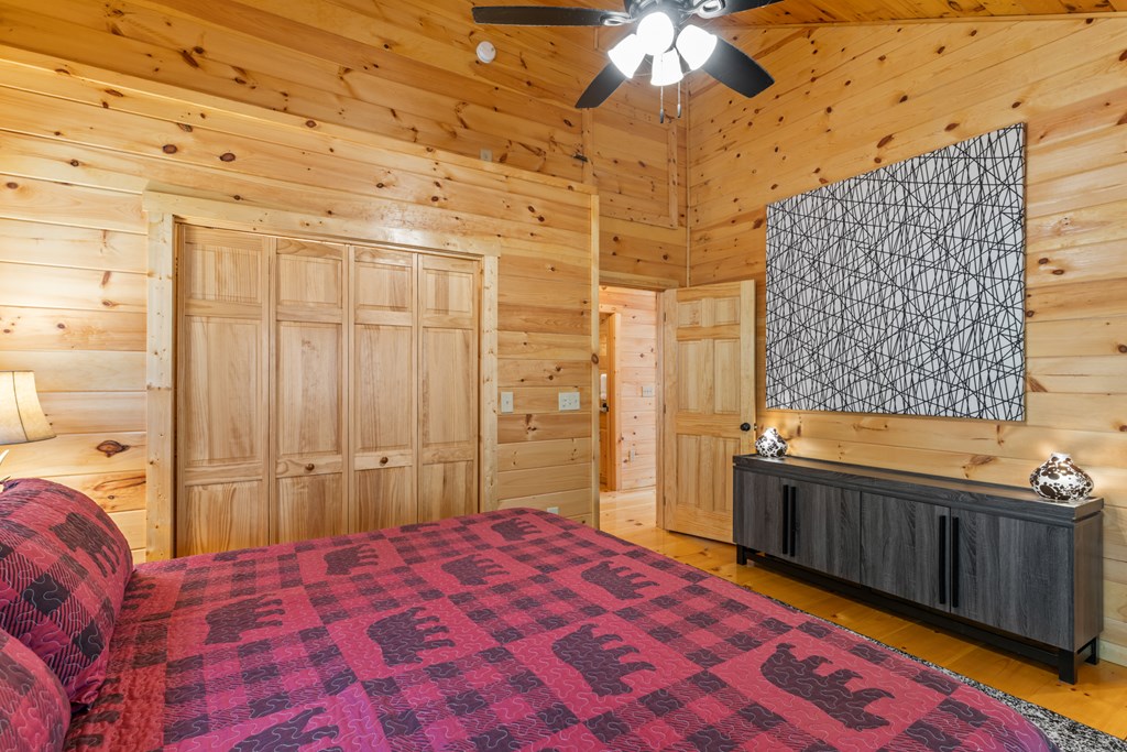237 Bentley Cove Murphy, NC 28906 - Photo 18 of 43 a bedroom with a bed and a chandelier
