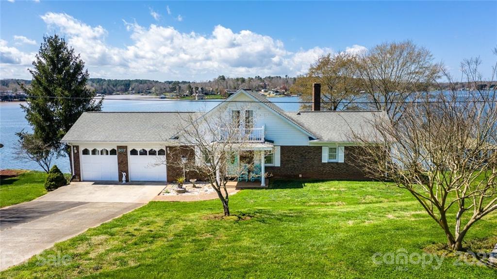 a view of a house with a big yard and potted plants