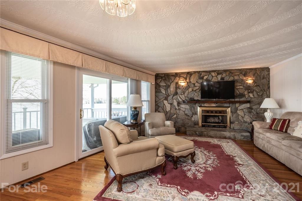 307 Kirkpatrick Road Taylorsville, NC 28681 - Photo 14 of 39 a living room with furniture a flat screen tv and a fireplace