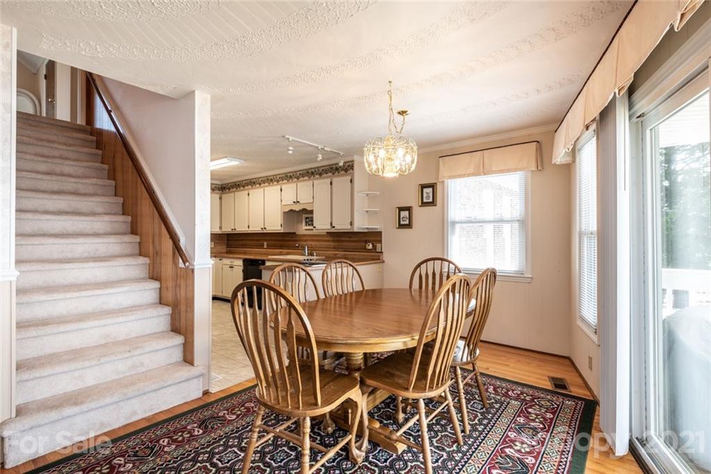 307 Kirkpatrick Road Taylorsville, NC 28681 - Photo 16 of 39 a view of a dining room with furniture window and wooden floor