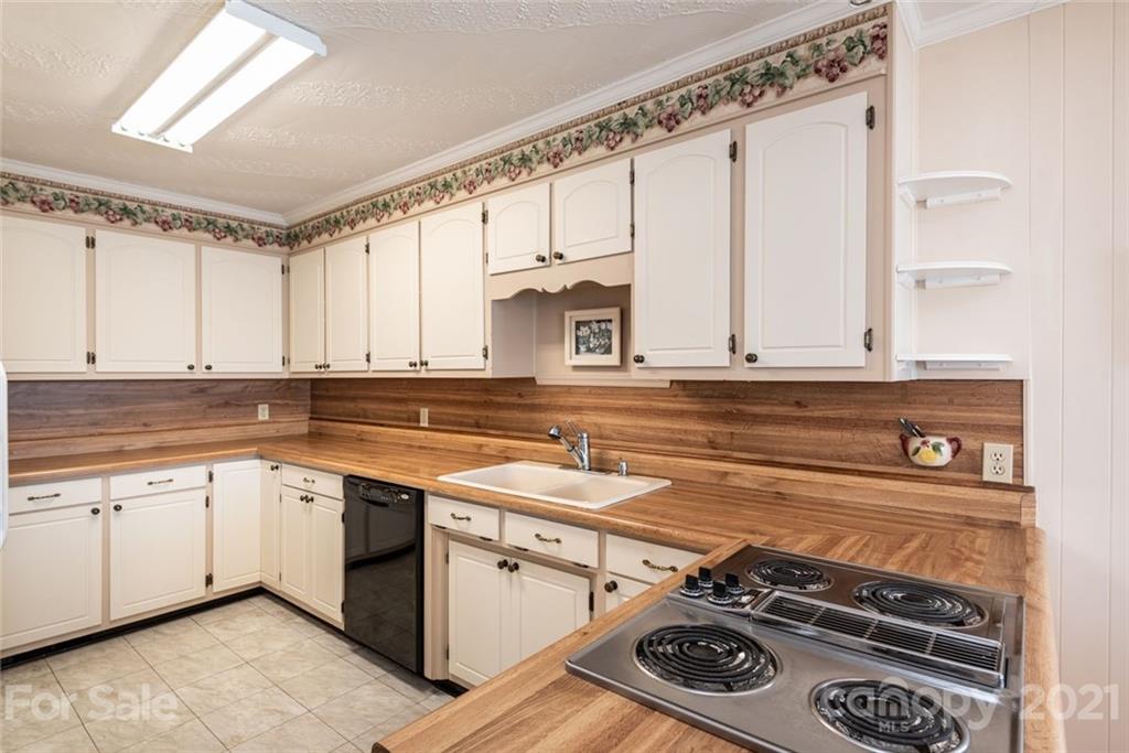 307 Kirkpatrick Road Taylorsville, NC 28681 - Photo 18 of 39 a kitchen with a stove and a sink