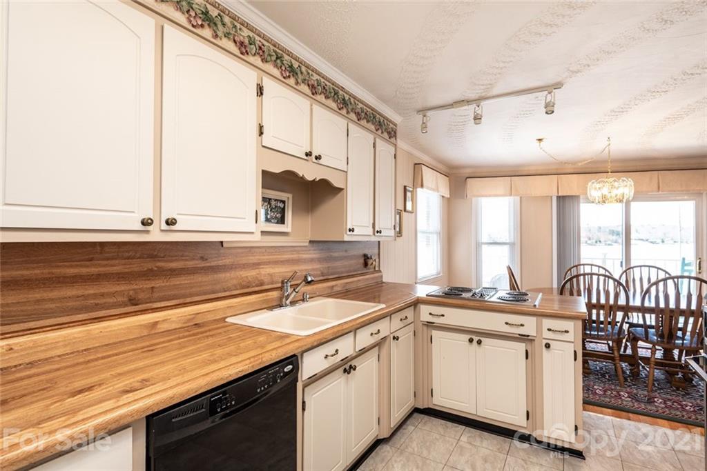 307 Kirkpatrick Road Taylorsville, NC 28681 - Photo 19 of 39 a kitchen with a sink stove and cabinets