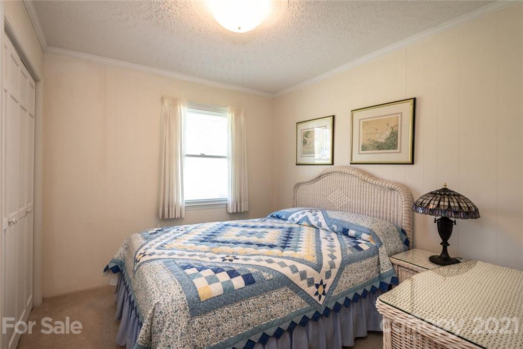 307 Kirkpatrick Road Taylorsville, NC 28681 - Photo 20 of 39 a bedroom with a bed and wooden floor