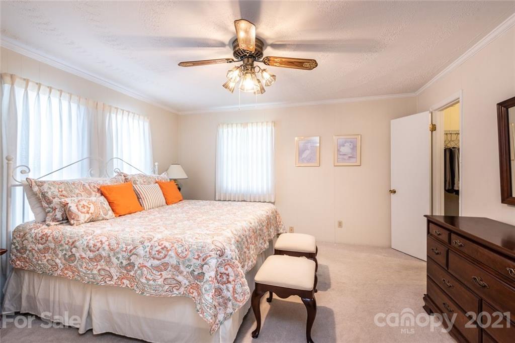 307 Kirkpatrick Road Taylorsville, NC 28681 - Photo 22 of 39 a bedroom with a bed and a chandelier