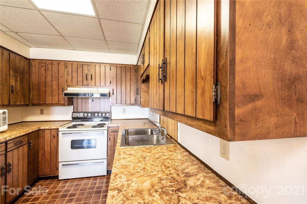 307 Kirkpatrick Road Taylorsville, NC 28681 - Photo 26 of 39 a kitchen with a stove a sink and a refrigerator