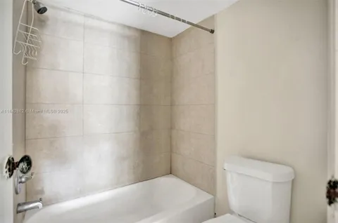 a bathroom with a shower and a toilet