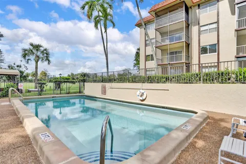 a view of swimming pool with a lounge chairs
