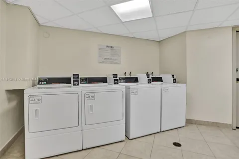 an aerial view of ocean with residential houses with outdoor space