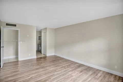 a view of an empty room and wooden floor