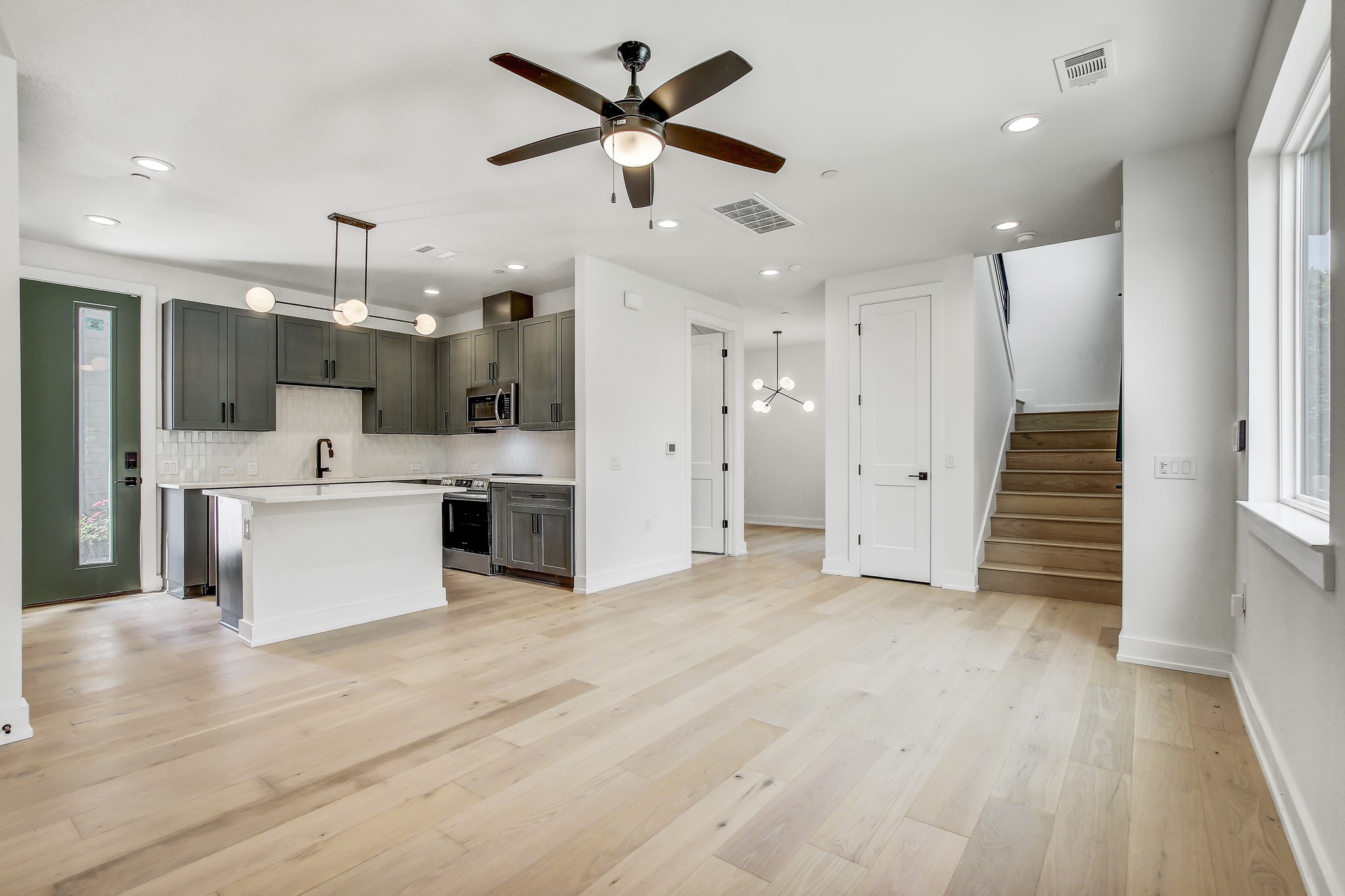 4127 East 12th Street, Unit 3 Austin, TX 78721 - Photo 7 of 29 Kitchen with appliances with stainless steel finishes, light countertops, ceiling fan, recessed lighting, and decorative backsplash