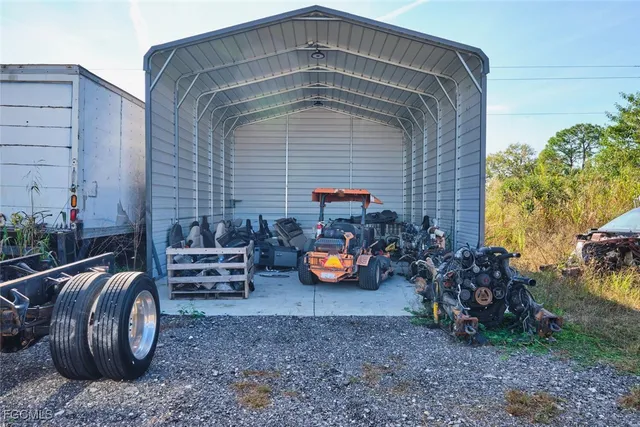 a backyard of a house with lots of furniture and outdoor seating