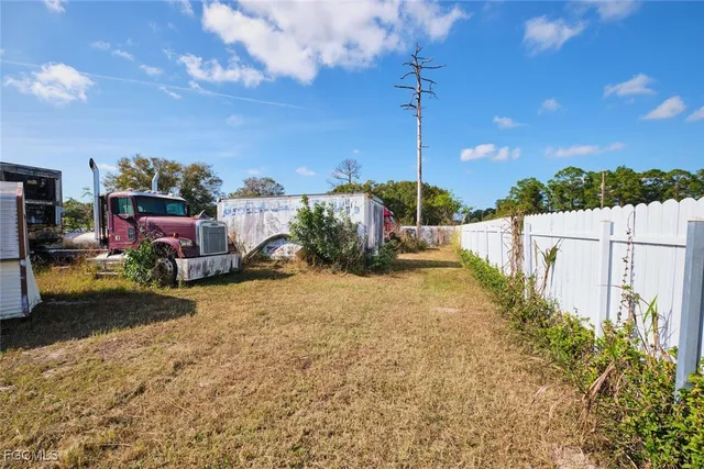 a view of a yard with table and chairs