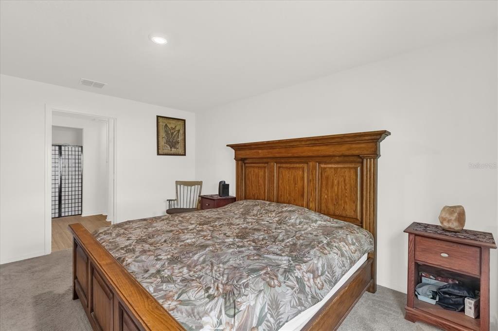 2134 Rio Grande Canyon Loop Poinciana, FL 34759 - Photo 12 of 22 a bedroom with a bed and a dresser