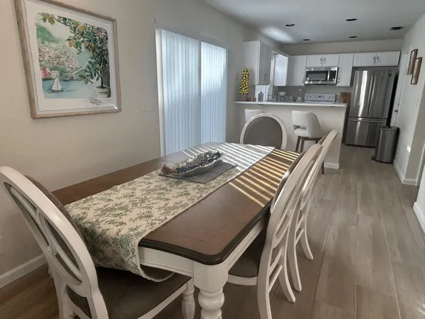 a view of a kitchen area kitchen island furniture and refrigerator