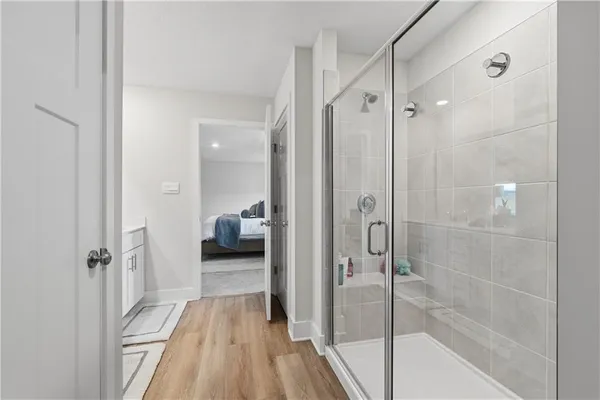 a bathroom with a shower and a glass door