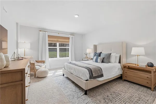 a spacious bedroom with a bed and a window