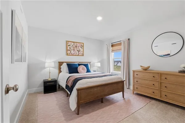 a bedroom with a bed and a dresser