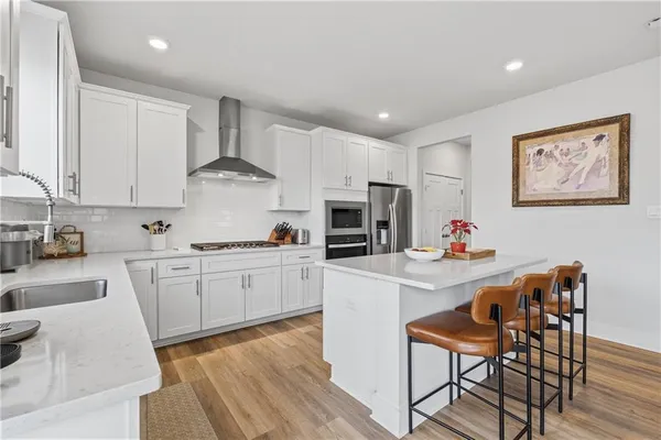 a kitchen with white cabinets and stainless steel appliances