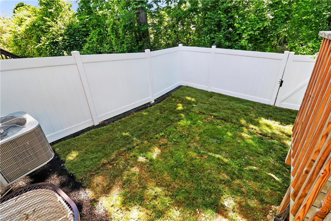 4502 Benjamin Court Emmaus, PA 18049 - Photo 18 of 48 A neatly maintained backyard features a new privacy fence and a fresh lawn, perfect for relaxation.