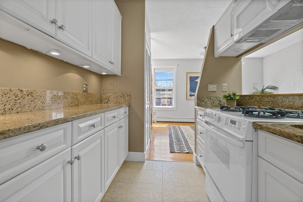 15 Dartmouth Place, Unit 3 Boston, MA 02116 - Photo 1 of 37 a kitchen with granite countertop white cabinets and white appliances