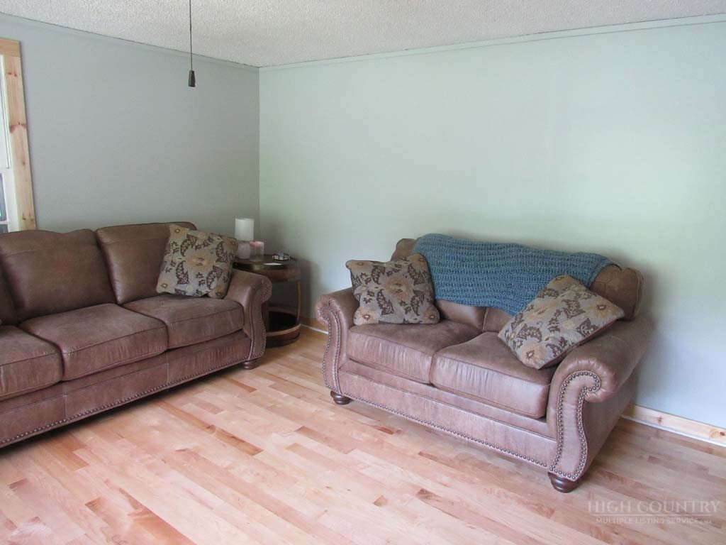 805 Ed Little Road Warrensville, NC 28693 - Photo 32 of 49 a living room with furniture and a couch