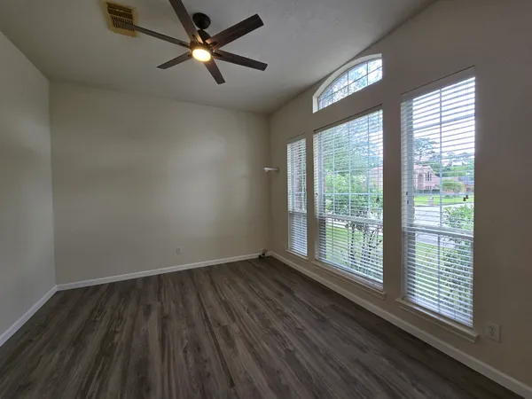 wooden floor in an empty room with a window