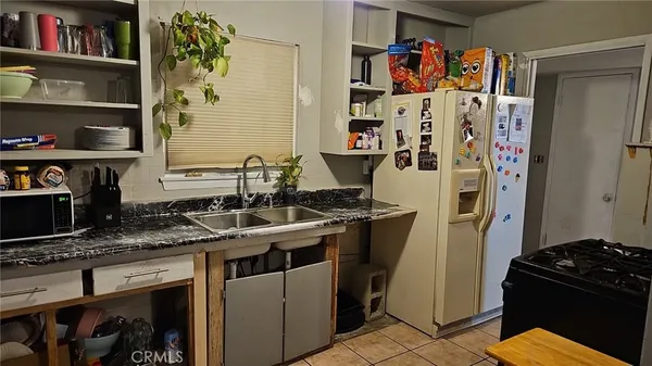 a kitchen with stainless steel appliances granite countertop a stove and a refrigerator
