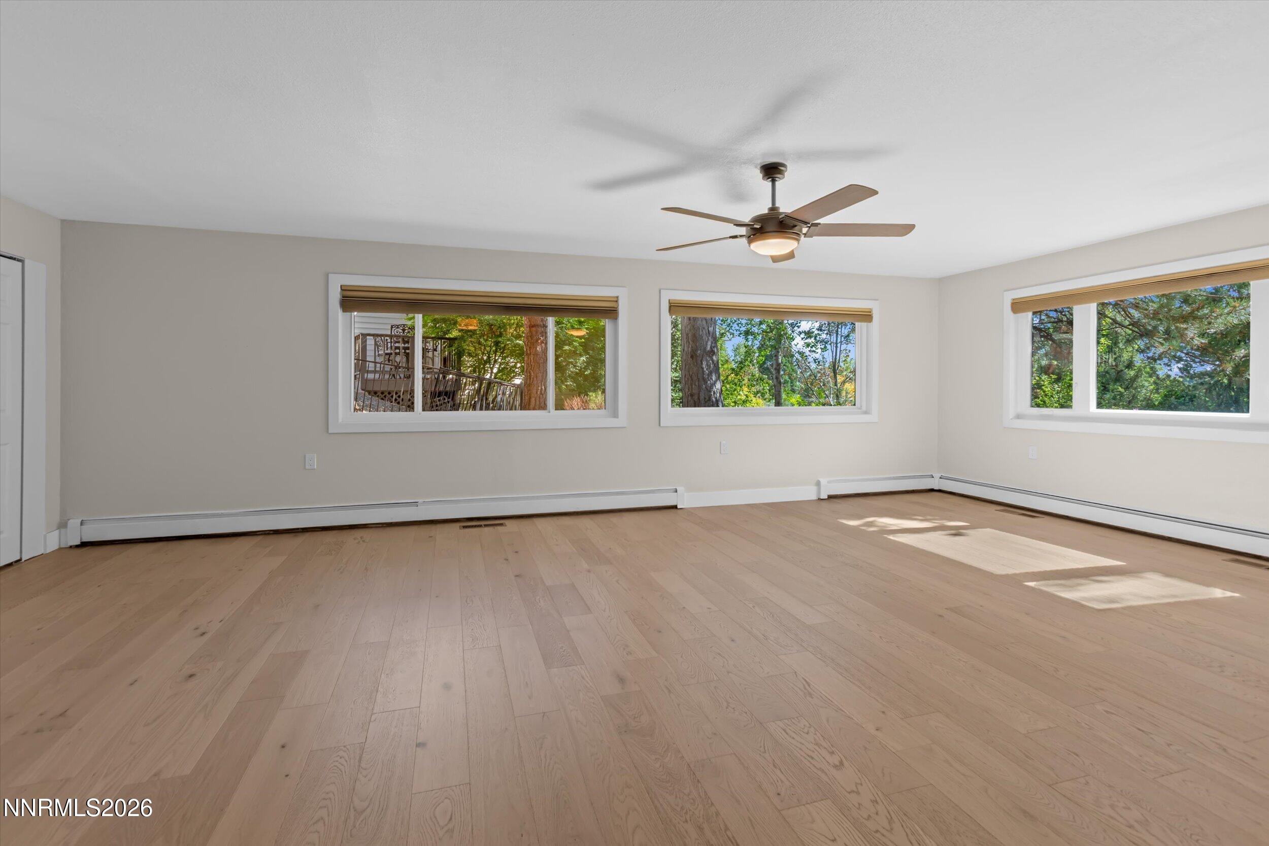2725 West Lake Ridge Shores Reno, NV 89519 - Photo 18 of 49 an empty room with windows and chandelier fan